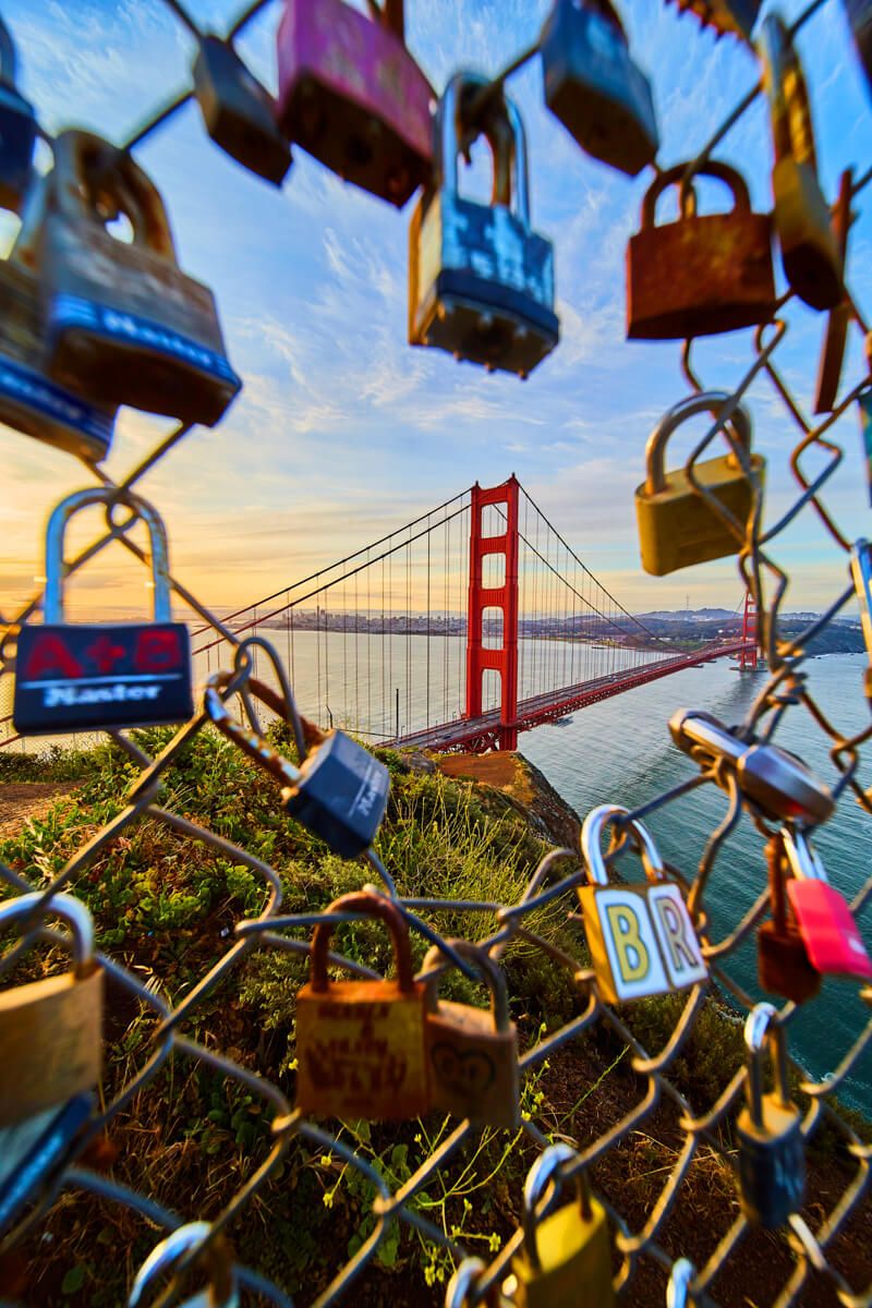 Golden Gate Bridge through fence of locks